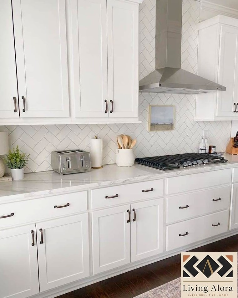 White Cabinets with a Herringbone Tile Backsplash